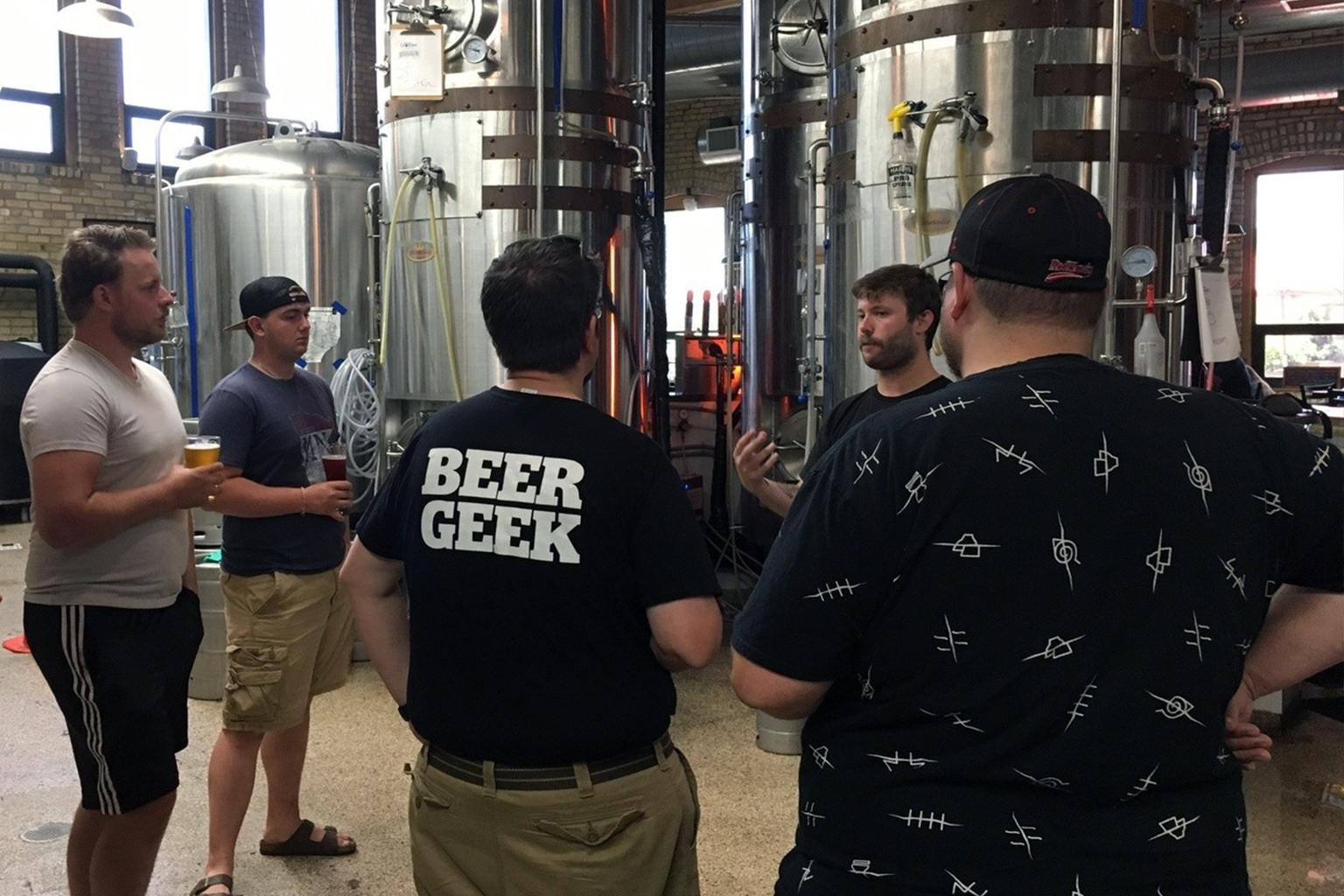A tour guide explaining the brewing process during at a beer factory.